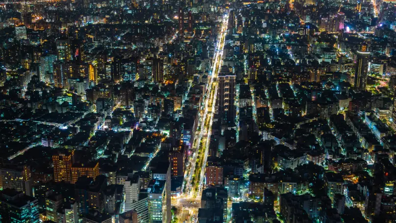 A modern city illuminated by electric lights, symbolizing Edison’s enduring impact.