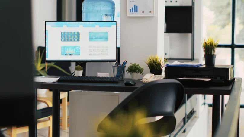 A modern office desk with a laptop