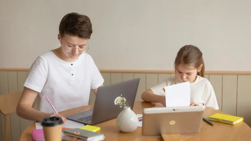  A parent and child planning their day together at a desk