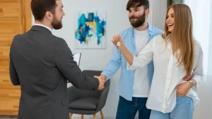 A real estate agent shaking hands with a client during a listing appointment.