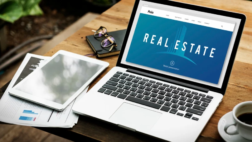 A sleek, modern real estate website on a laptop screen.