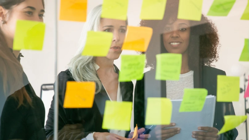 A team brainstorming session with sticky notes and a visible timeline.