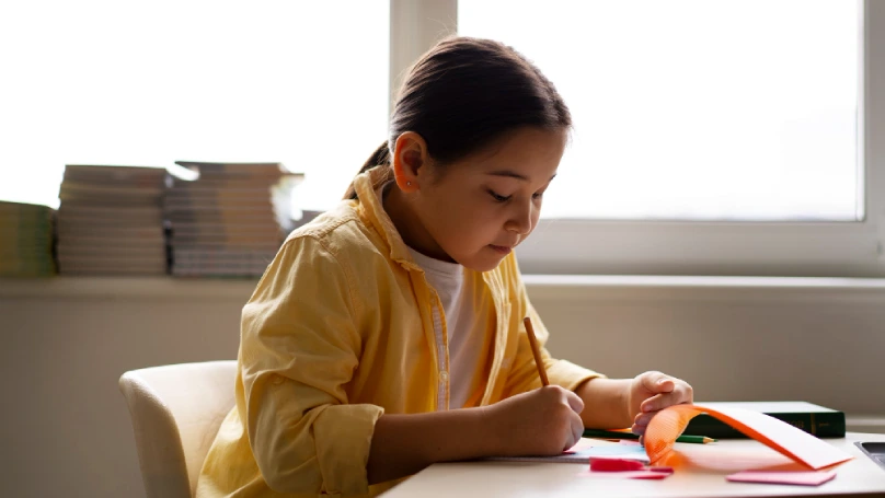 child happily checking off tasks 