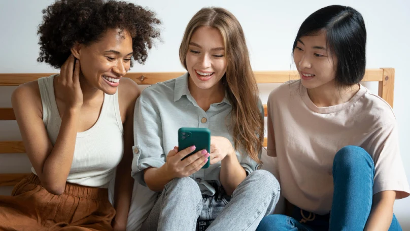 group of women laughing and chatting online